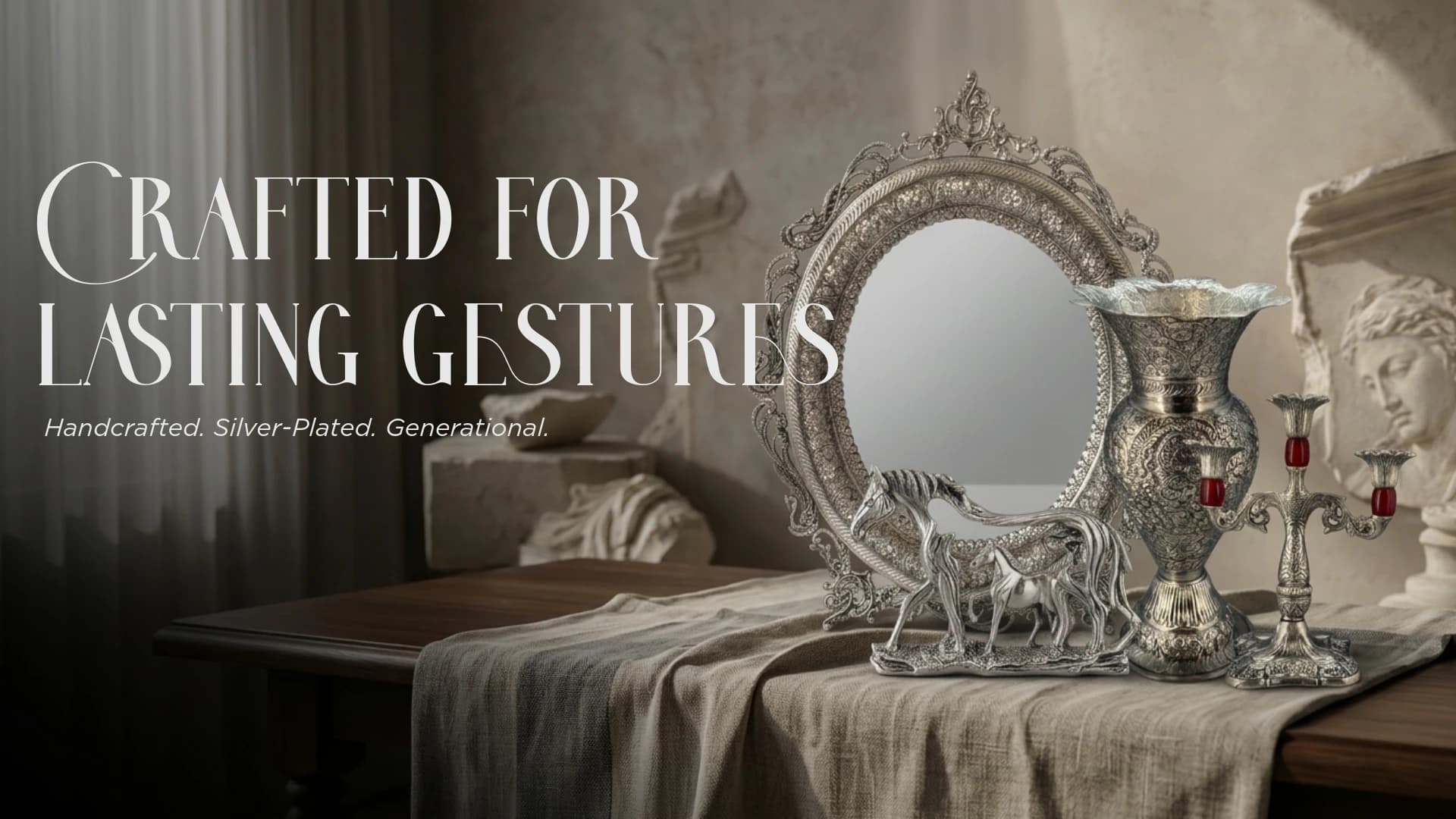 A silver-plated wall mirror, engraved vase, horse pair and candelabra arranged on a linen runner in a sunlit room.